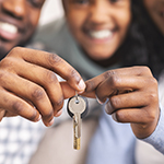 family holding house keys